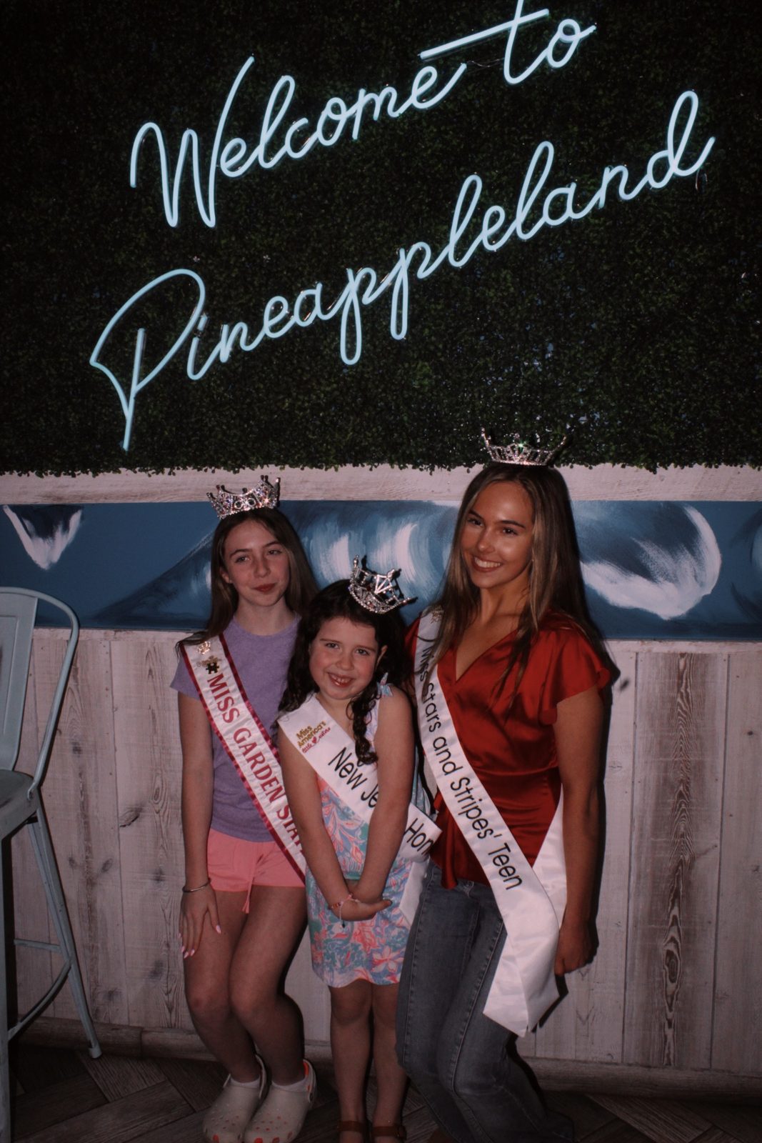 Kayla with fellow titleholders in sashes and crowns