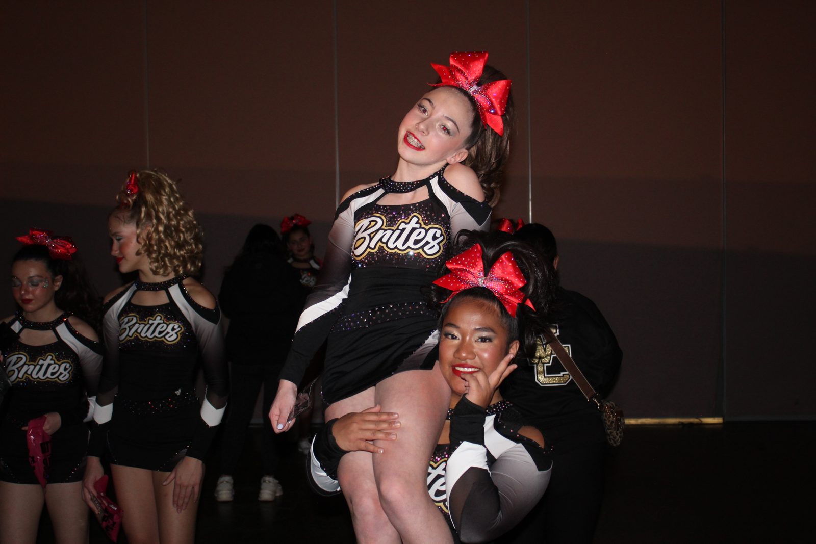 Kayla celebrating with cheer teammates