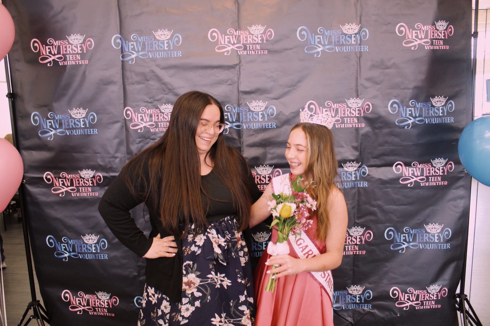 Kayla in her sash with a friend at a pageant event